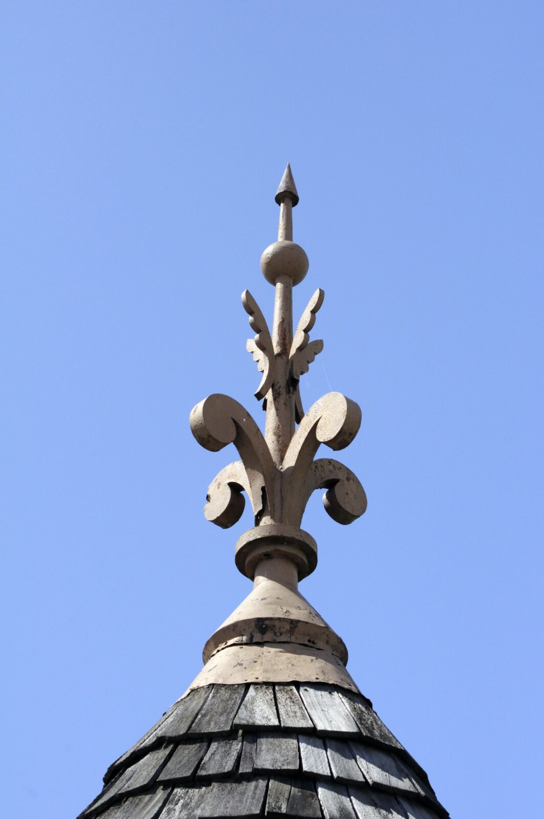 Metal finial atop the turret's candle snuffer roof
